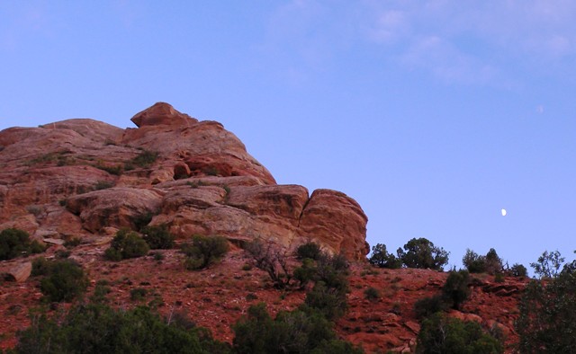 Moon over red rocks in Dinosaur